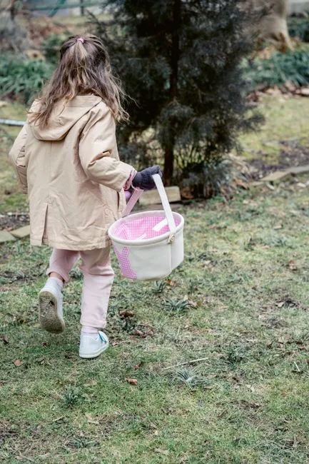 An outdoor-themed Easter basket filled with colorful sidewalk chalk, a small watering can, bubbles,
